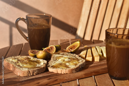 Rustic Mediterranean summer snack with figs, honey and cheese