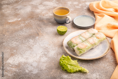 Vietnamese shrimp spring rolls on brown concrete. side view, copy space