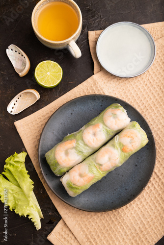 Vietnamese shrimp spring rolls on black concrete. top view, flat lay, close up