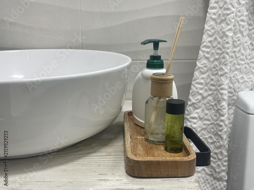 wooden bowl in the bathroom with shampoo flavoring agent and liquid soap