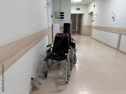 Empty wheelchairs placed along the corridor of a hospital waiting for patients and caregivers to use them during their visit