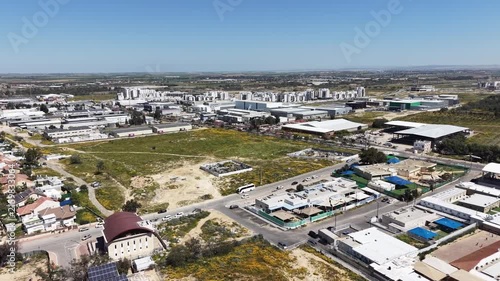 Aerial drone view of Ofakim city and industrial area in southern Israel with urban landscape and infrastructure