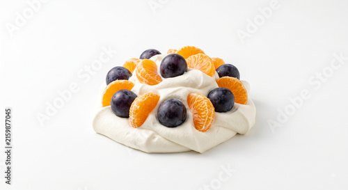 Distant shot of 5 to 10 Kyoho grapes and Redhyang mandarin segments nestled on thick white cheese cream