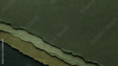 Dark olive green torn paper background, textured recycled paper layers with deckle edges, minimalist earth tone craft paper stationery
