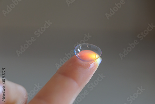 Foto Contact lens on fingertip ready for insertion and clear vision