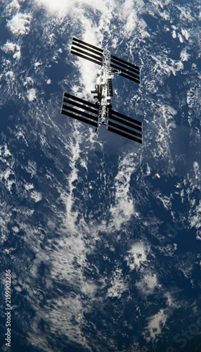 A manned orbital station orbiting earth with solar panels and clouds