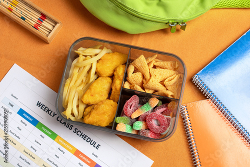 Junk food kids nutrition concept, unhealthy school lunchbox