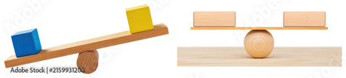 Konstfotografi Two wooden seesaws with blocks, one with colored blocks and one with blank woode