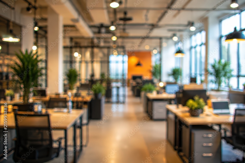 Fototapeta premium blurred modern open plan office interior with industrial lighting and indoor plants.