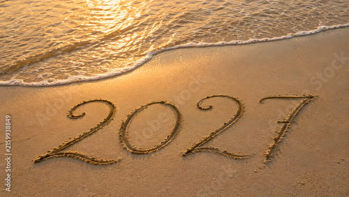 2027 Written in Sand by Ocean Waves for New Year and Fresh Start Concept