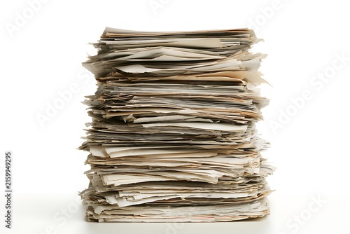A large chaotic stack of old paper documents isolated on white background