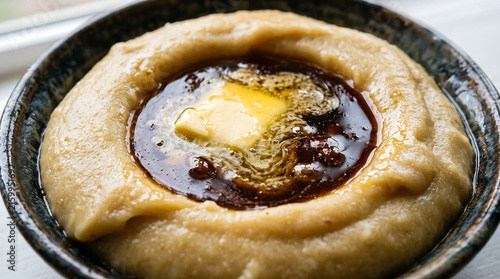Traditional Libyan Asida Flour Dough Ring Filled with Date Molasses and Melting Butter Close-Up