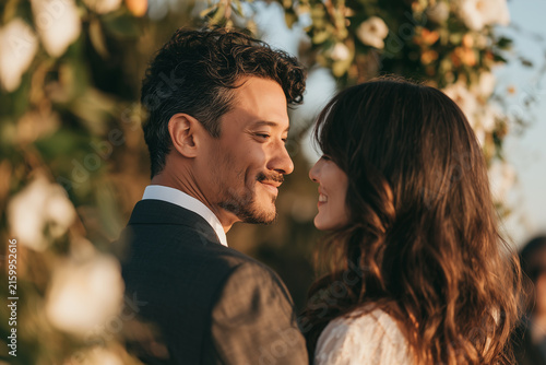 Multicultural couple sharing intimate moment during ceremony.