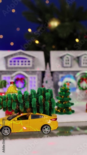 A car drives past a Christmas town decorated with laser beams