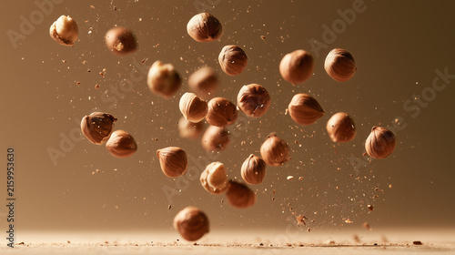 Nuts falling in dynamic motion against a minimal backdrop.
