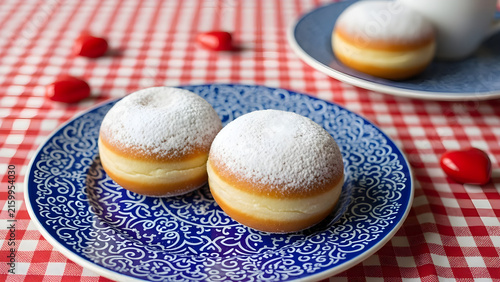 Freshly Baked Soft Donuts Dusted with Powdered Sugar Served on Traditional Decorative Ceramic Plates for a Delicious Morning Breakfast Treat