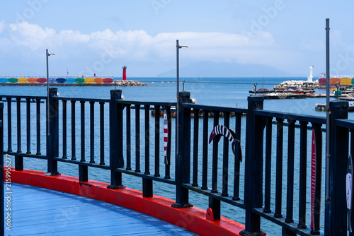 Coastal Pier Boardwalk Railing Overlooking Harbor Breakwater and Lighthouses