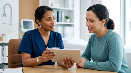 Doctor shows patient medical results on tablet in bright, modern clinic office