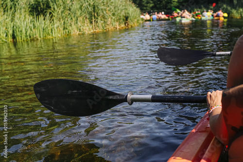 Canvastavla Two paddles extend over calm river water