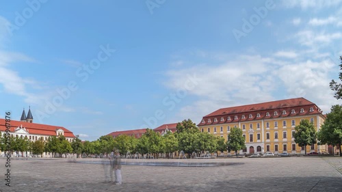 Cathedral Square, Magdeburg, Saxony-Anhalt, Germany; the State Parliament on the left side, the Ministry of Justice and Consumer Protection opposite, time-lapse with motion blur of people