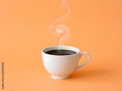 A steaming white cup of freshly brewed black coffee on an orange background