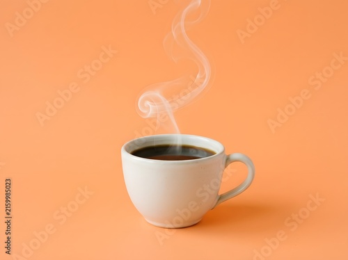 Steaming Cup of Fresh Black Coffee Against a Vibrant Orange Backdrop