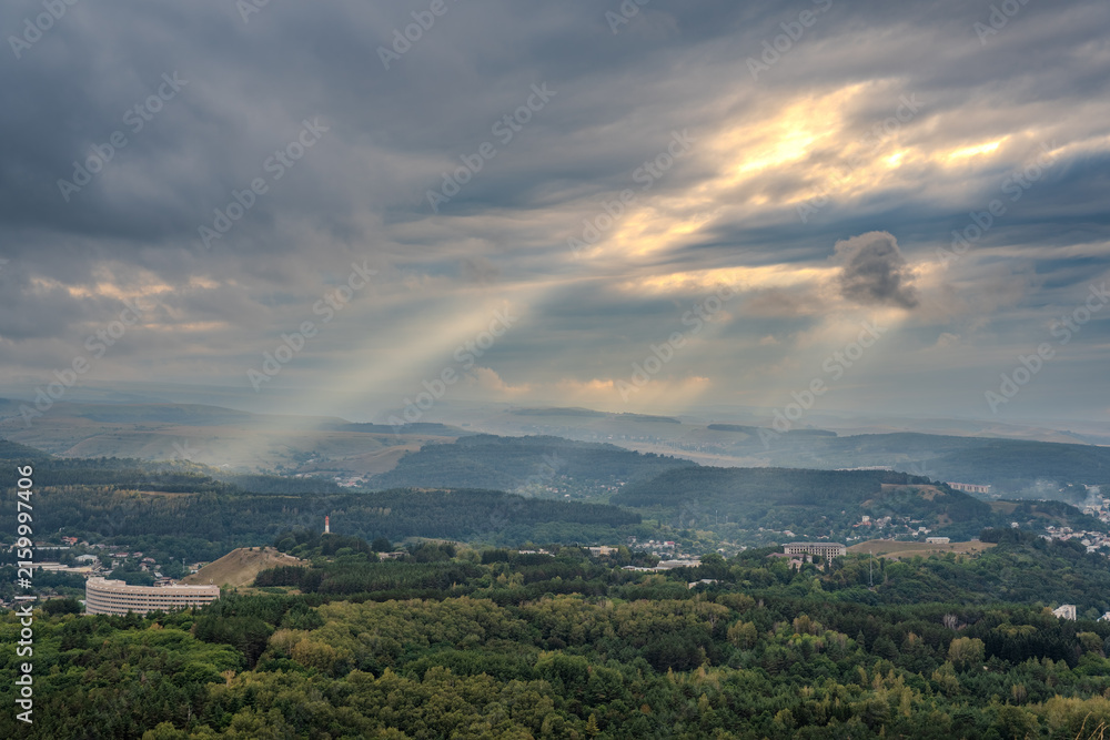 Obraz premium View of the mountains and Kislovodsk from the observation decks of the Kislovodsk Park. Evening sunset over the mountains of Kislovodsk.