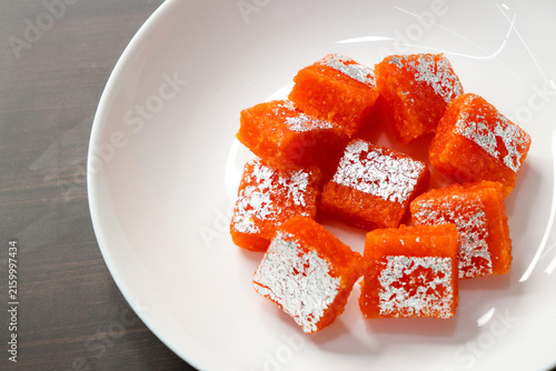 Nagpur Orange Barfi. Traditional Indian mithai made with milk solids and fresh Nagpur orange pulp. Soft, creamy fudge texture with tangy citrus flavor, inspired by India’s Orange City.