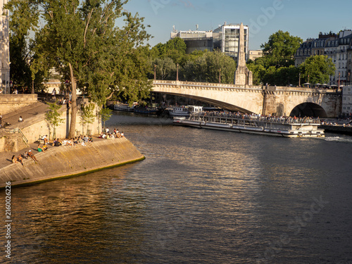 Cuadro en lienzo A cruise ship carrying tourist sightseers passes under a bridge on the Seine Riv