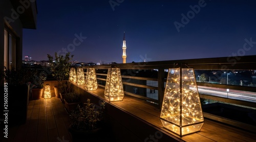 Glowing lanterns on balcony overlooking night city skyline.