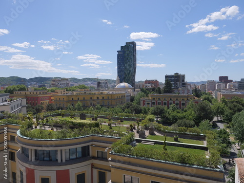View of the cityscape of Tirane, featuring a green roof, the dome of the Et'hem Bey Mosque, and a modern skyscraper Tirane, Tirana County, Albania.