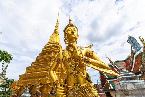 Golden angel mythical creature statues stand in Wat phra kaew grand palace buddha temple