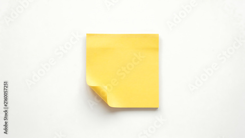 Blank yellow adhesive note, memo pad with curled corner isolated on white background