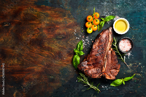 T-bone black agus steak with sea salt, butter and spices. Juicy steak grilled. Top view.