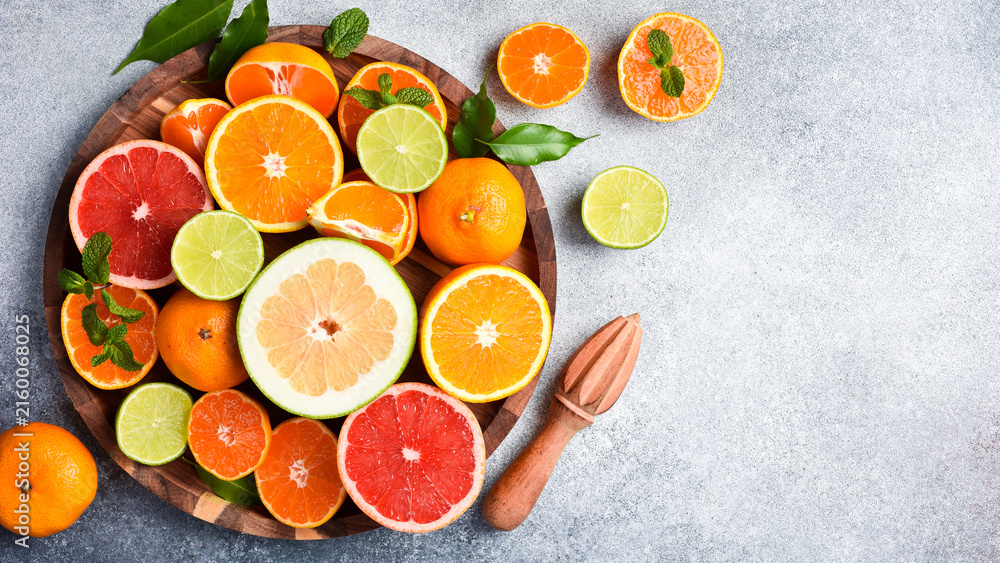 Fototapeta premium Assortment of colored citrus fruits: tangerine, grapefruit, lime and orange. Top view. Citrus fruits.