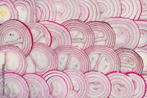 Bild auf Leinwand Red onion rings sliced texture background, Group of chopped onion top view