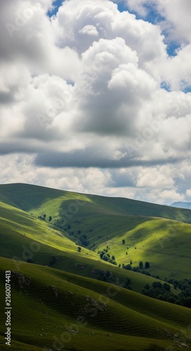 Bright white clouds casting soft shadows over rolling green hills