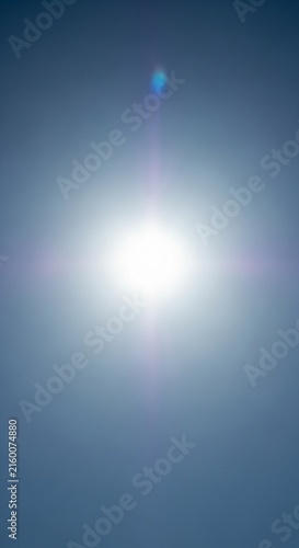 Bright white sun shining in a clear blue sky