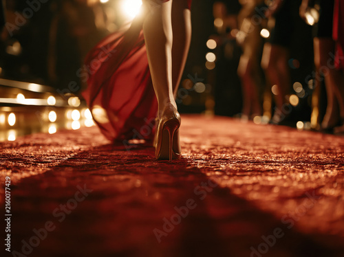 Woman in red dress walking on red carpet