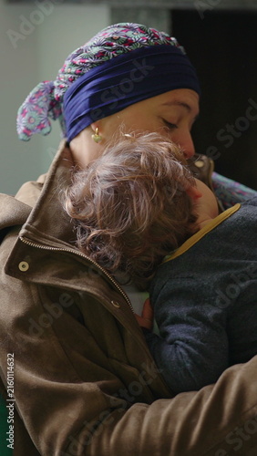 Mother embracing toddler during health recovery at home, touching family moment expressing resilience, support, attachment and emotional wellbeing