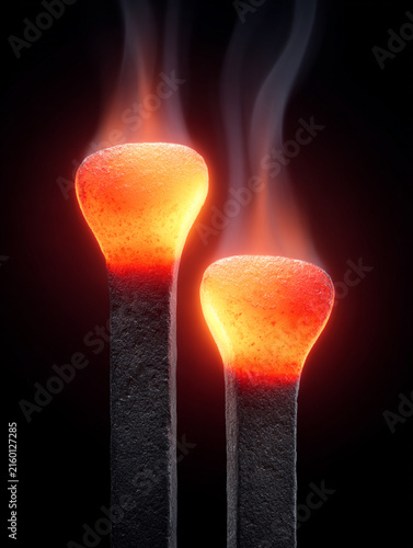 Glowing Matchsticks with Smoke on a Dark Background