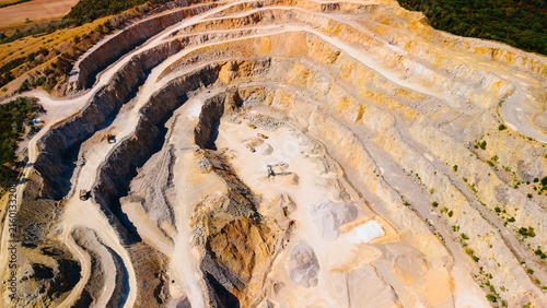 Obraz na plátne Terraced opencast rock quarry with working excavators