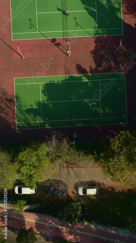 Top down aerial view of multiple outdoor tennis courts