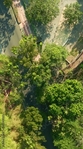 Aerial view of winding canal through lush Yogyakarta urban park