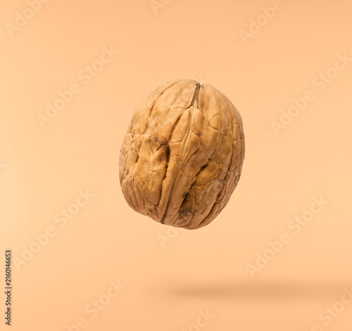Canvastavla Fresh raw walnut flying in the air