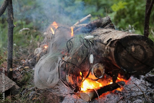 Disposal by burning illegal fishing nets.
