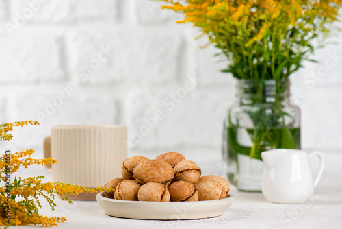Vegan sugar and gluten free cookies filled with coconut condensed milk served with coffee and autumn flowers
