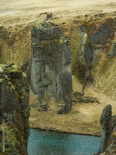 Moss-covered volcanic rock formations in Icelandic canyon