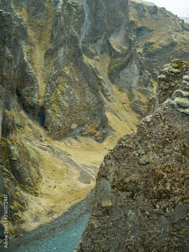 Moss-covered volcanic rock formations in Icelandic canyon