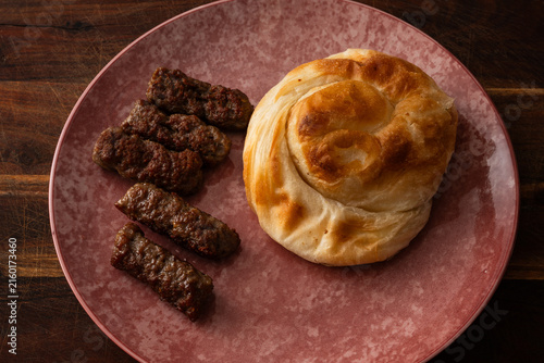 Картината върху платно typical Balkan dish consisting of cevapi, grilled minced meat rolls, accompanied